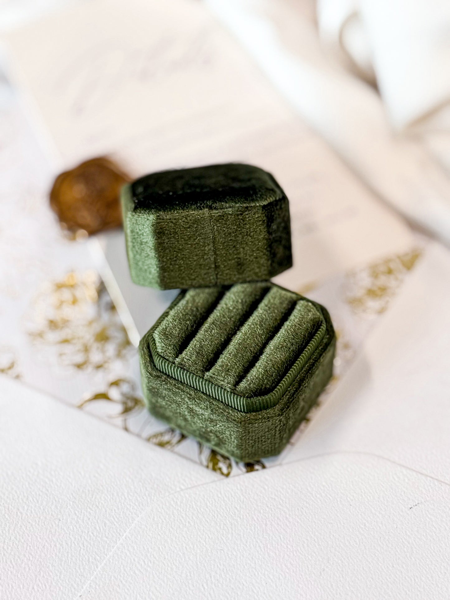 Green velvet jewelry box on a light background