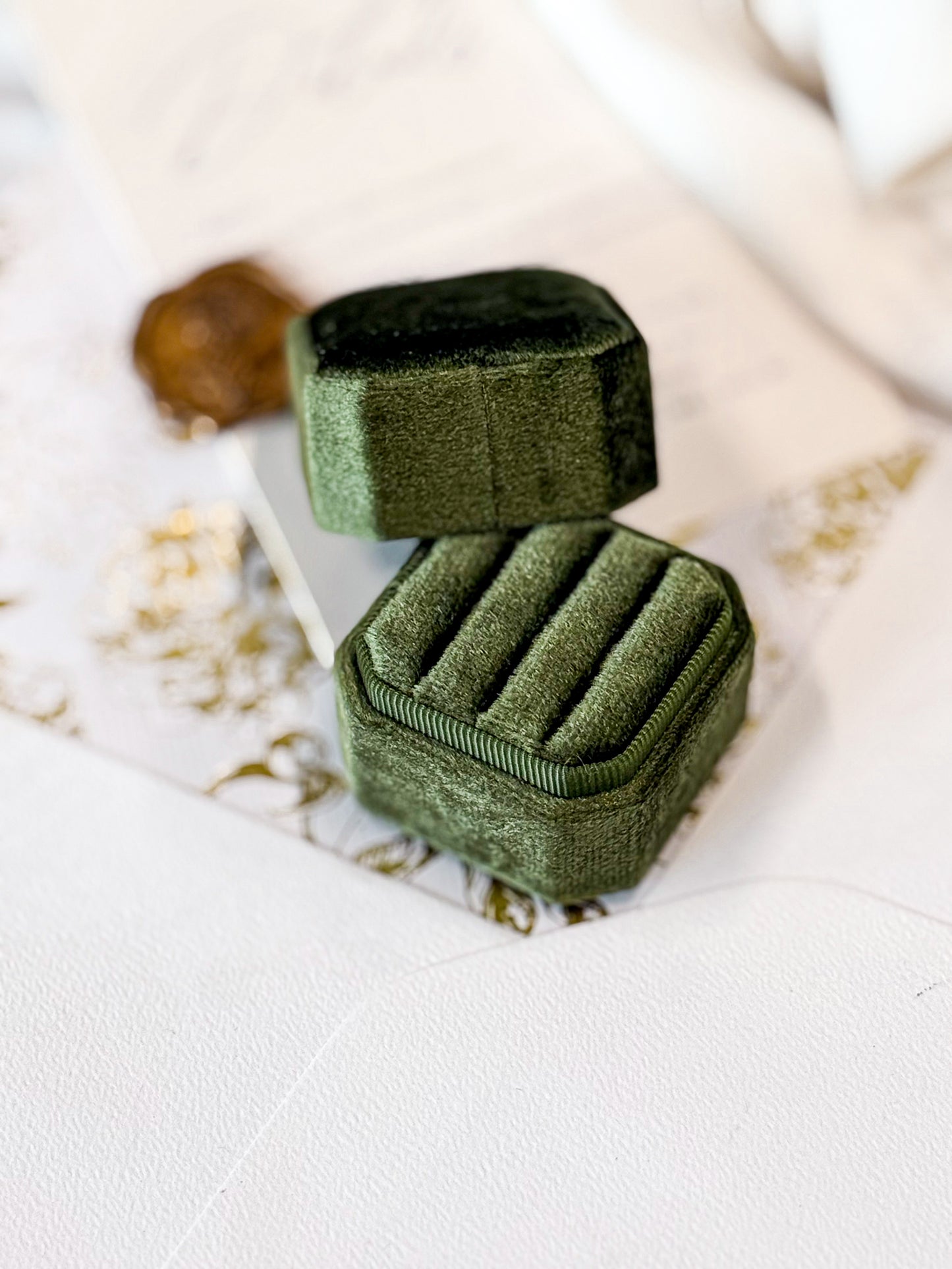 Green velvet jewelry box on a light background