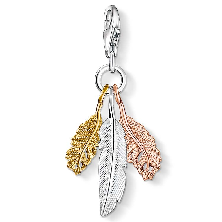 Jewelry charm with three leaf-shaped pendants in gold, silver, and rose gold on a white background.