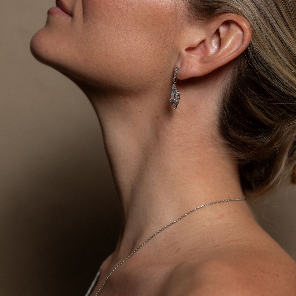 aquamarine diamond earrings drop placed on girls ear mclean & co Australia