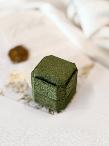 Green jewelry box on a light surface with a blurred background
