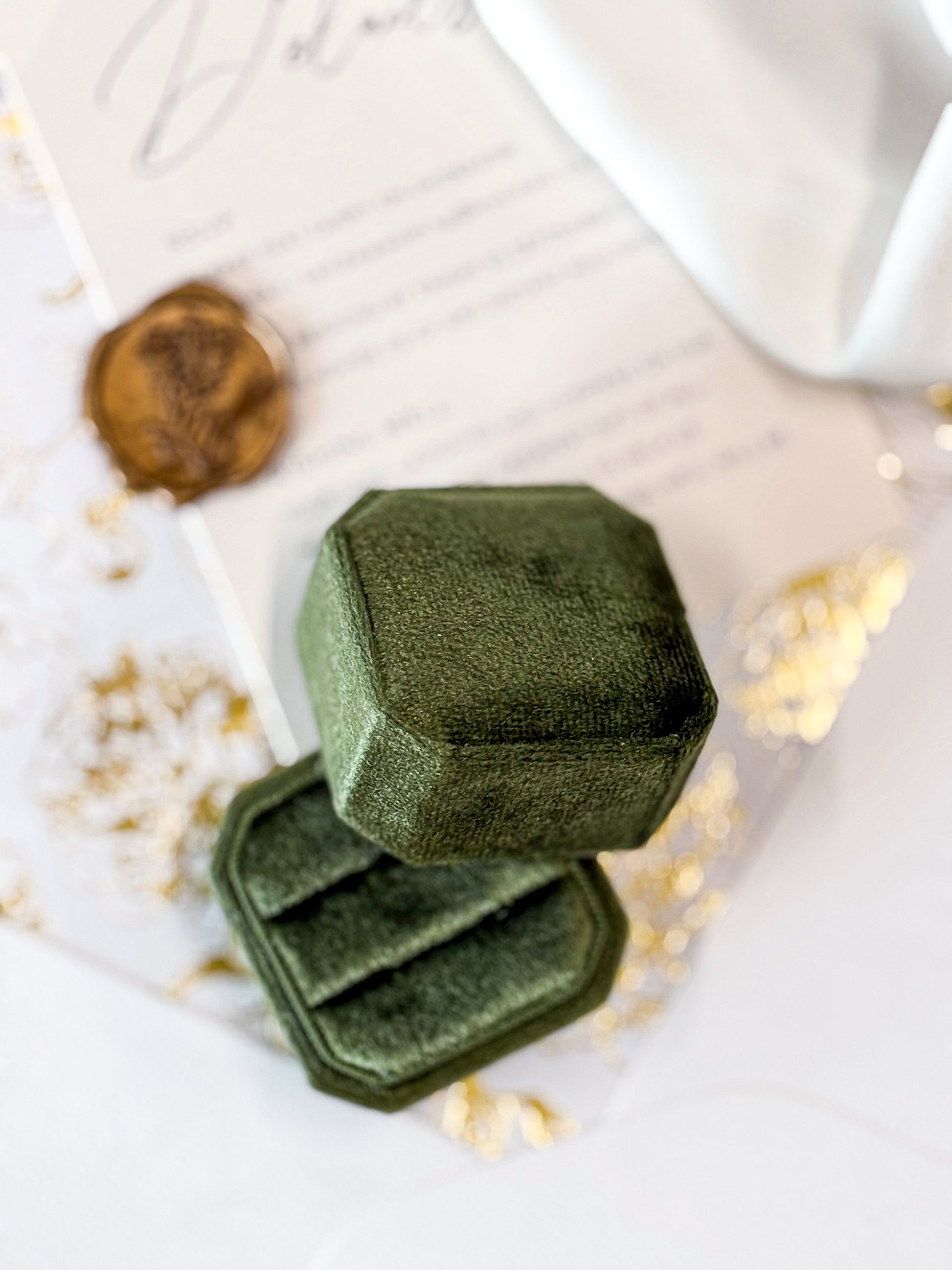 Green velvet ringbox on wedding stationery